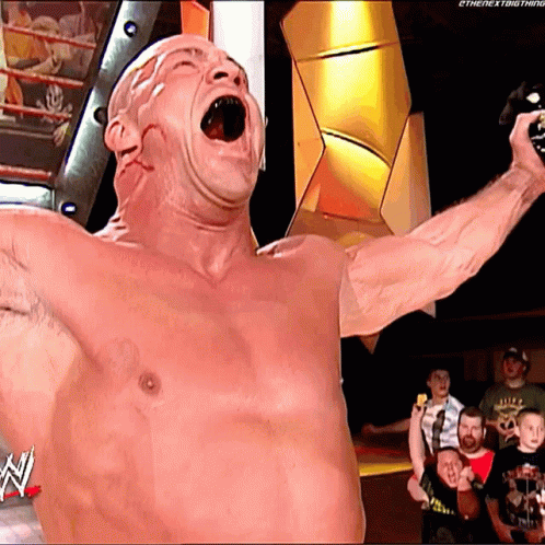 Shirtless Wrestler Holding Microphone With N On Bottom GIF
