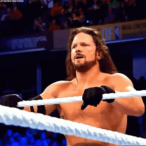Shirtless Wrestler Holding Rope In Ring GIF
