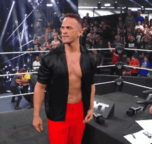 Shirtless Wrestler In Black Jacket And Red Pants GIF