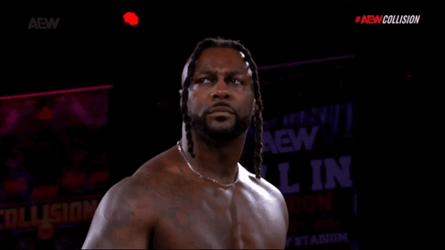 Shirtless Wrestler in Front of AEW Collision Sign