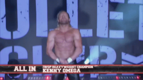 Shirtless Wrestler in Front of All In Kenny Omega Sign