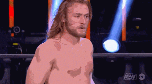 Shirtless Wrestler in Ring With AEW Logo