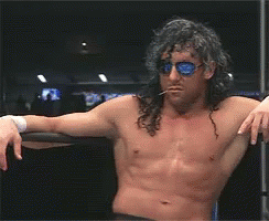 Shirtless Wrestler Long Hair Sunglasses Leaning on Railing