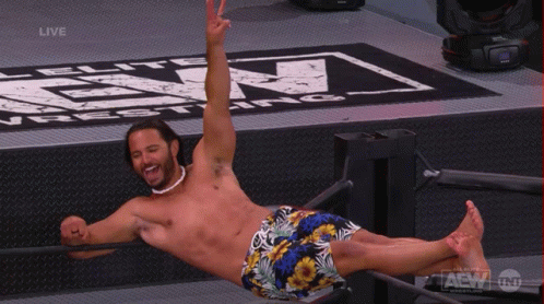 Shirtless Wrestler Lying on Back in Ring