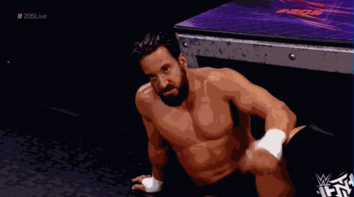 Shirtless Wrestler Sitting on Floor