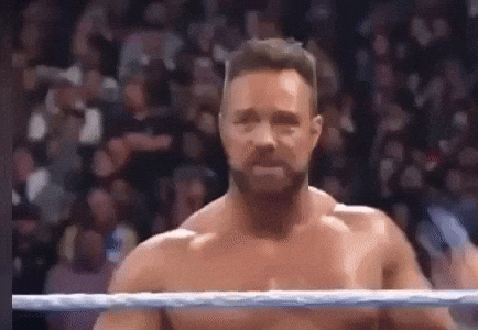 Shirtless Wrestler Standing in Ring