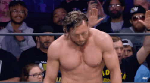 Shirtless Wrestler Waving to Crowd