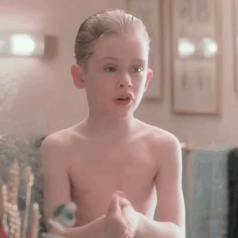 Shirtless Young Boy Covering Face in Mirror