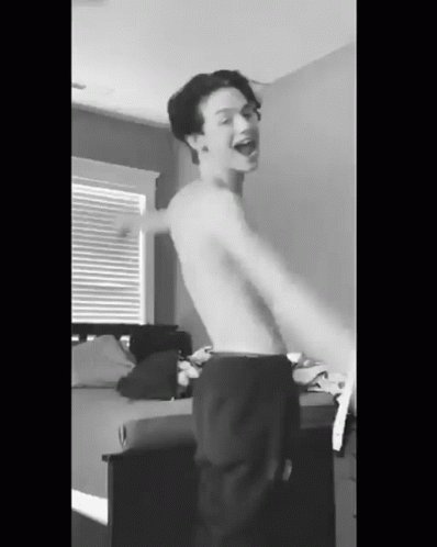 Shirtless Young Man Dancing in Bedroom