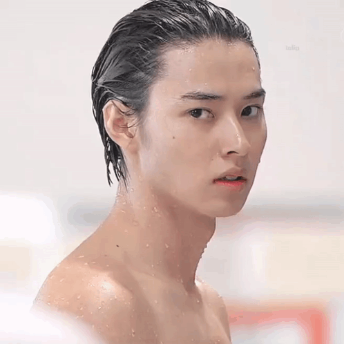 Shirtless Young Man With Wet Hair Looking at Camera