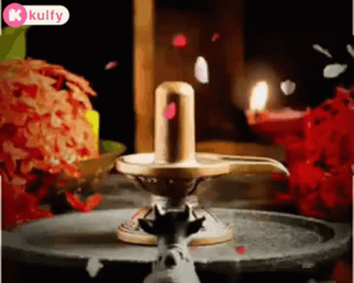 Shiva Lingam With Candles and Flowers