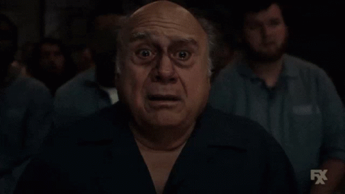 Shocked Man In Front Of Group With FX Logo GIF