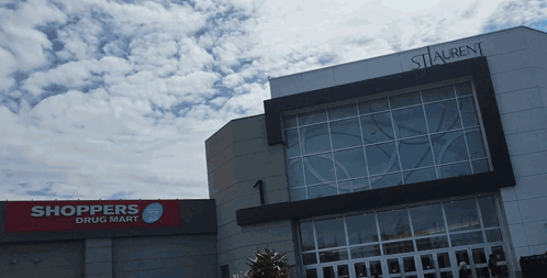 Shoppers Drug Mart In Front Of Large Building GIF