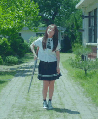 Cute High School Girl Holding Shotgun GIF
