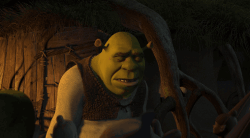 Shrek Covering His Eyes With His Hand And The Word Okay Written Below Him GIF