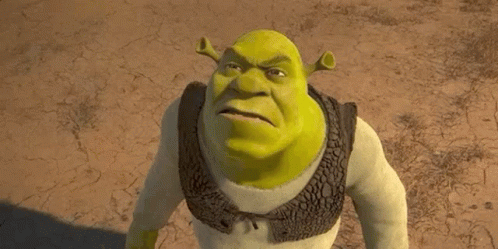Shrek From The Movie Shrek Is Standing In The Dirt And Looking At The Camera . GIF