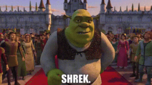 Shrek From The Movie Shrek Is Standing On A Red Carpet In Front Of A Crowd Of People GIF