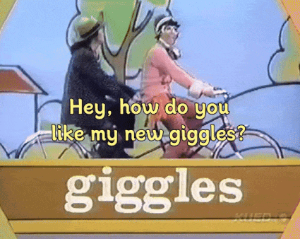 Sign Saying Giggles With Two People Riding Bicycles