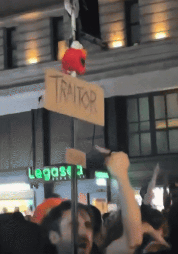 Sign Saying Traitor Hanging from Pole