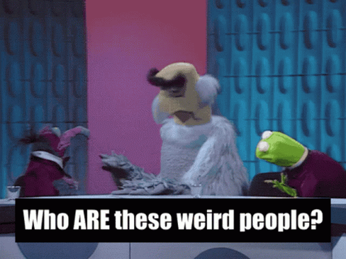 Sign Saying Who Are These Weird People Next to Stuffed Animals