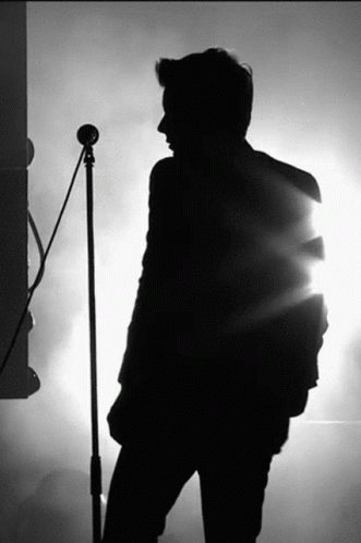 Silhouette Man Singing Into Microphone