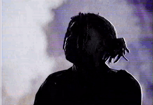 Silhouette Man With Dreadlocks in Dark Room