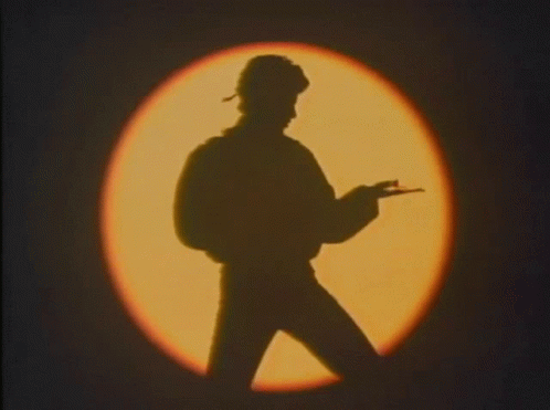 Silhouette Of Man Holding Gun By Circle Of Light GIF