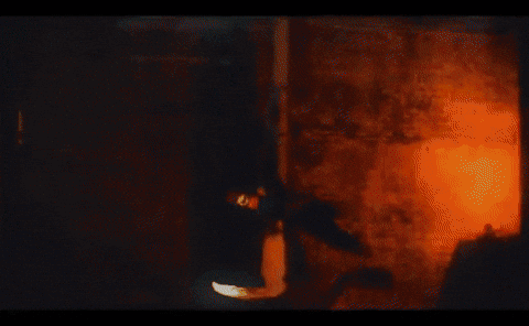 Silhouette Of Man In Front Of Orange And White Painting GIF