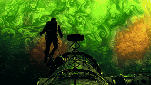 Silhouette of Man on Green and Orange Object