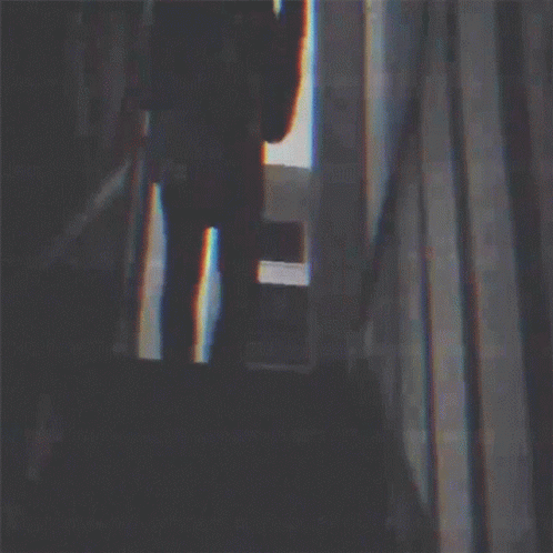Silhouette of Man Playing Guitar in Dark Room