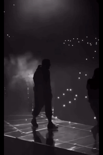 Silhouette Of Man Walking On Stage GIF