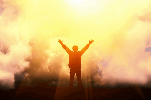 Silhouette of Man With Arms Outstretched in Front of Sun