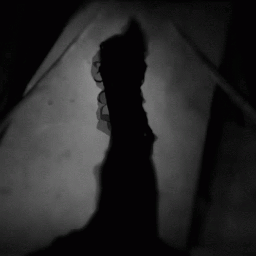 Silhouette of Person With Glowing Eyes