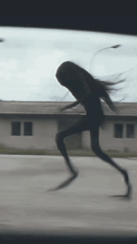 Silhouette Running Down Street