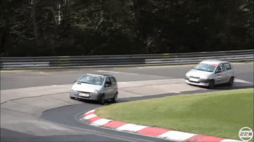Silver Car Driving On Road With Hedge Behind GIF