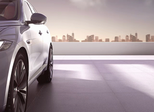 Silver Car Parked on Rooftop With City Skyline