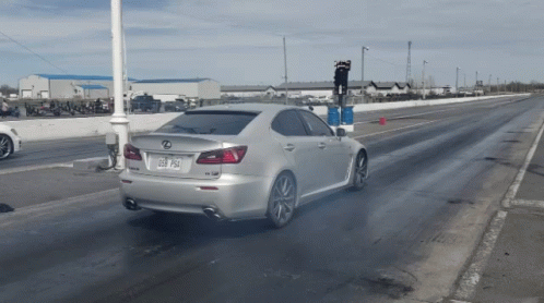 Silver Lexus Driving on Race Track With License Plate 058 Psa