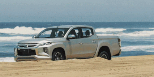 Silver Mitsubishi Truck on Sandy Beach