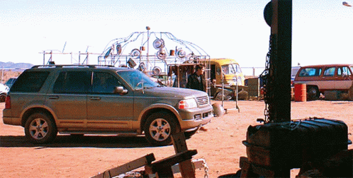 Silver SUV Parked in Dirt Field