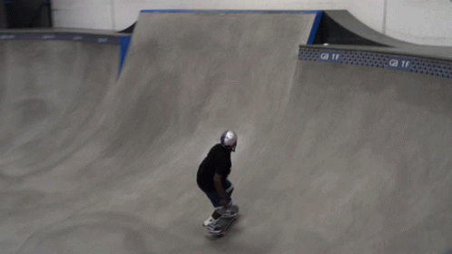 Skateboarder Doing Trick On Ramp In Front Of GMT Sign GIF