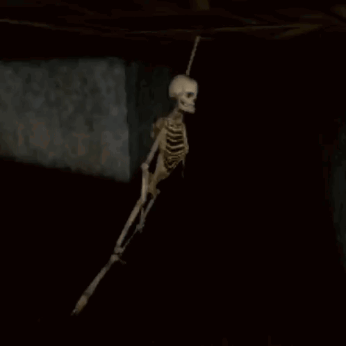 Skeleton Hanging From Ceiling In Dark Room Video Game GIF