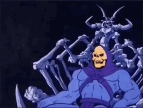 Skeletor Standing Next to Skeleton Statue
