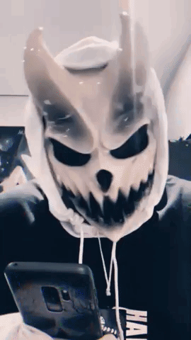 Skull Mask Person on Couch Phone