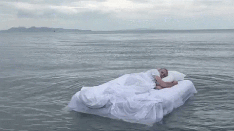 Sleeping Man Floating On The Ocean GIF