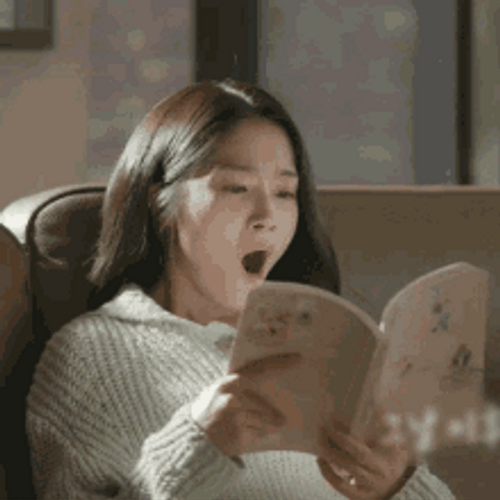 Sleepy Woman Reading Book Yawning GIF