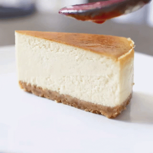 Slice of Cheesecake With Cherry Sauce
