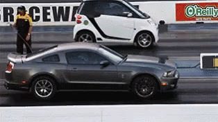 Smart Car and Mustang Racing on Track