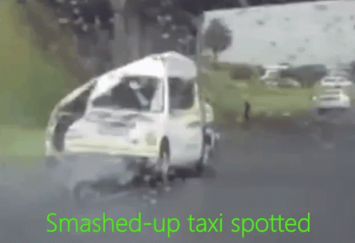 Smashed Up Taxi Driving Down Road