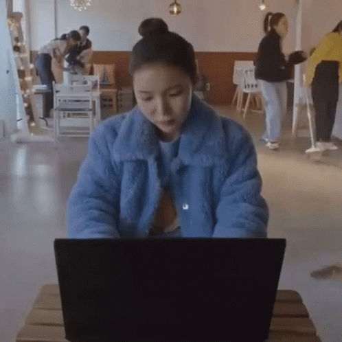 Asian Lady Smashing Computer In Coffee Shop GIF