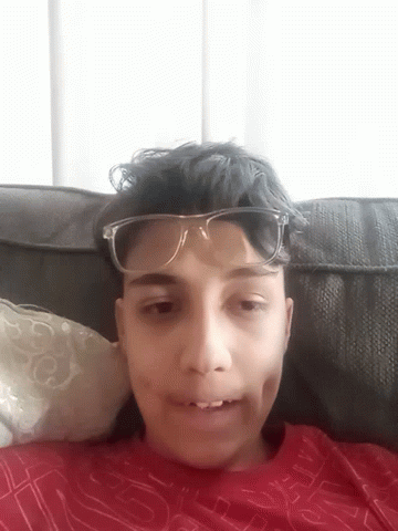 Smiling Boy in Glasses and Red S Shirt